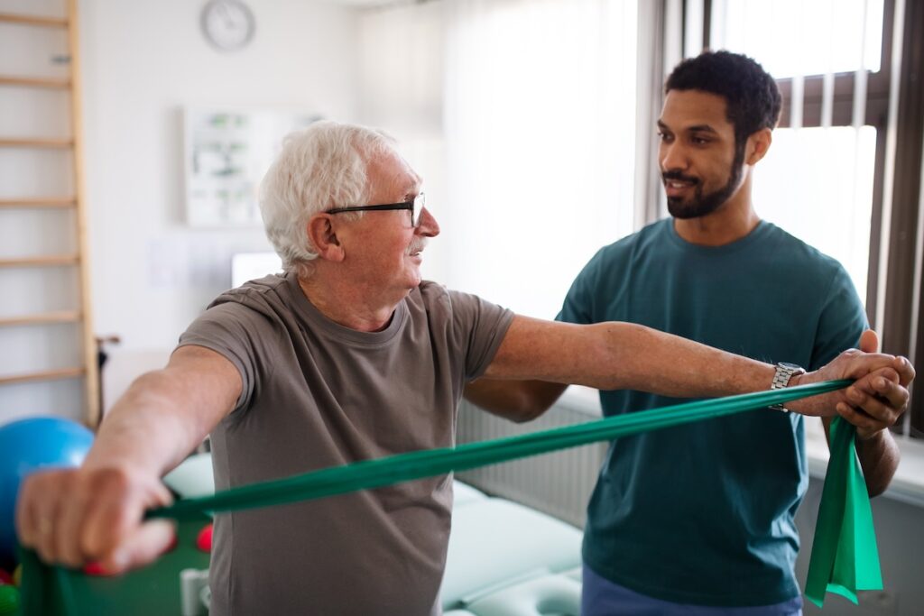 Senior man getting physical therapy